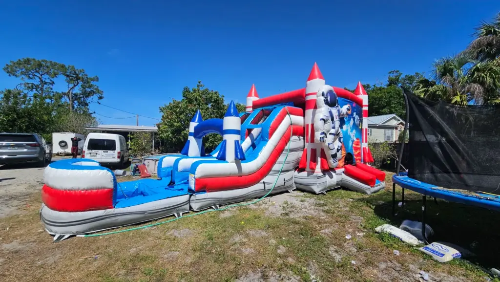 Family First inflatable party rentals in North Fort Myers, FL featuring a rocket themed bounce house