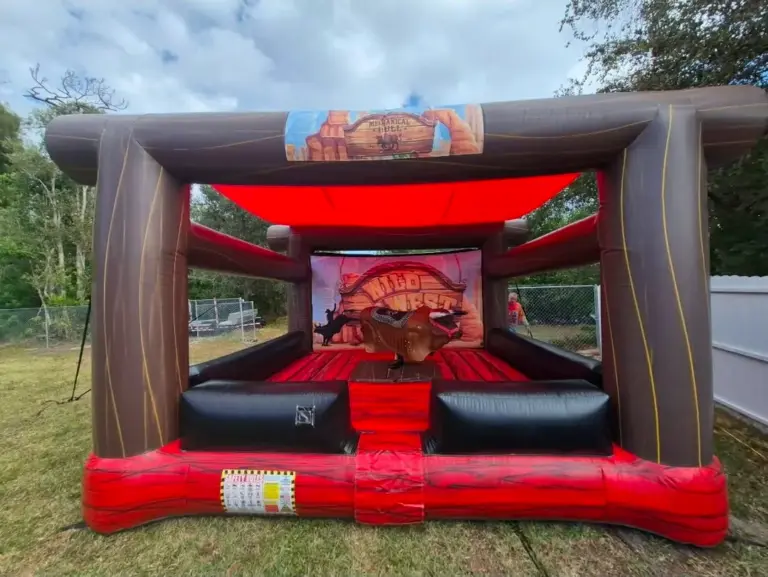 Party rentals Cape Coral FL — Wild West mechanical bull inflatable arena set up in a backyard for a party