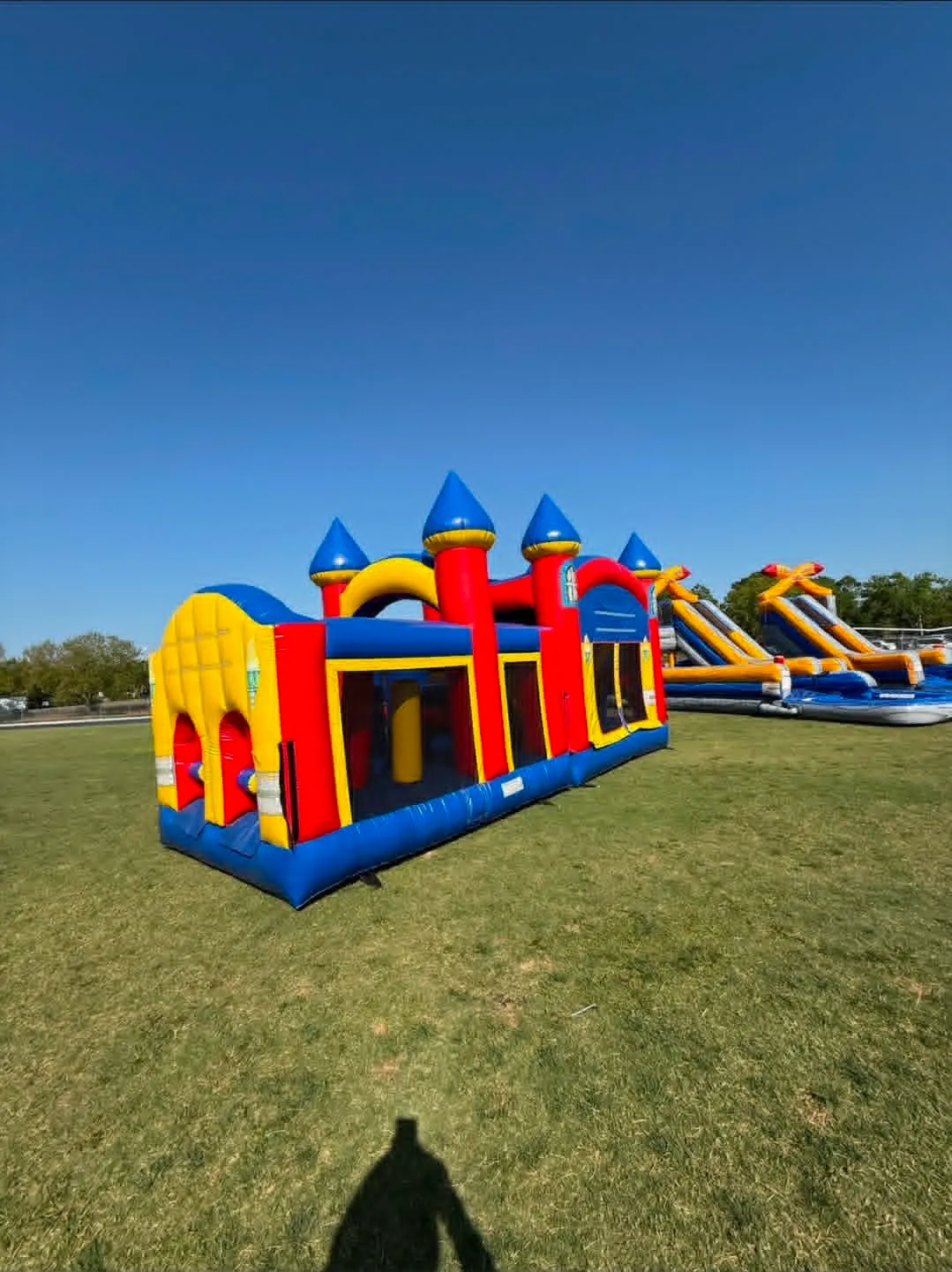 Castle obstacle course with a slide set up on grass for a North Fort Myers party