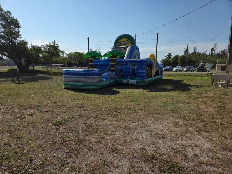 Tropical obstacle course, water slide, rentals in Buckingham FL with palm trees and splash pool