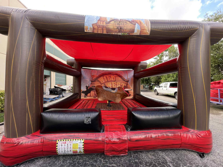 Mechanical Bull Rentals in Fort Myers, FL: staffed Wild West-themed bull with padded safety mat, delivered by Family First Events & Rentals