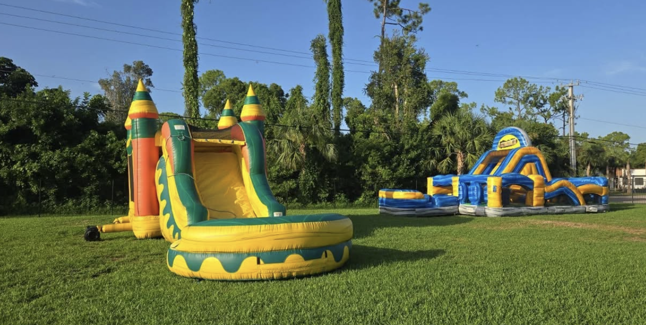 Bounce house and water slide combo with an obstacle course set up in a backyard for a birthday party in Cape Coral, Florida
